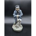 A Royal Copenhagen figurine Shepherd boy with dog. [19cm in height]