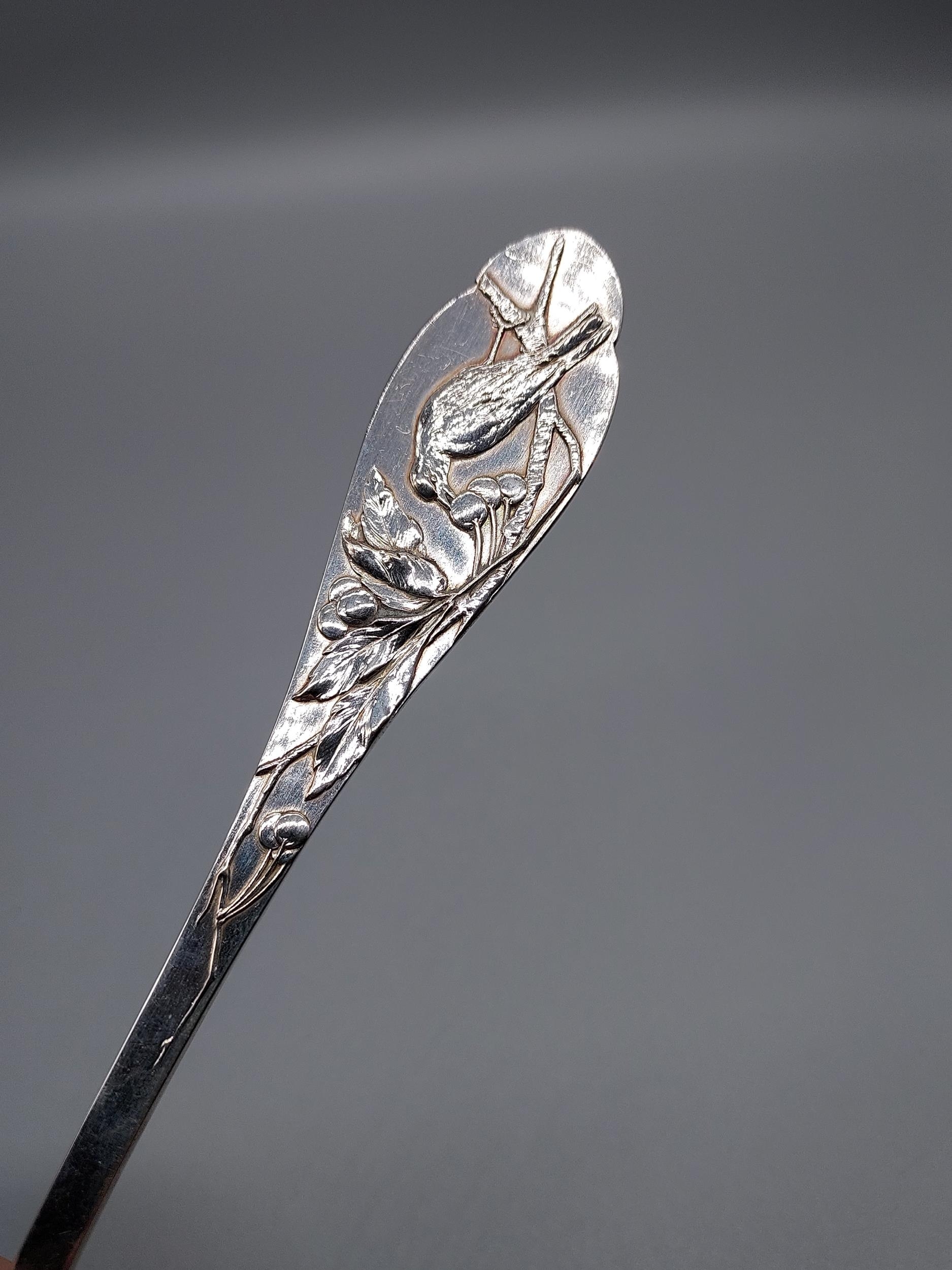 A German 800 Silver marked desert spoon, Designed with a raised relief bird eating berries. [19. - Image 4 of 4