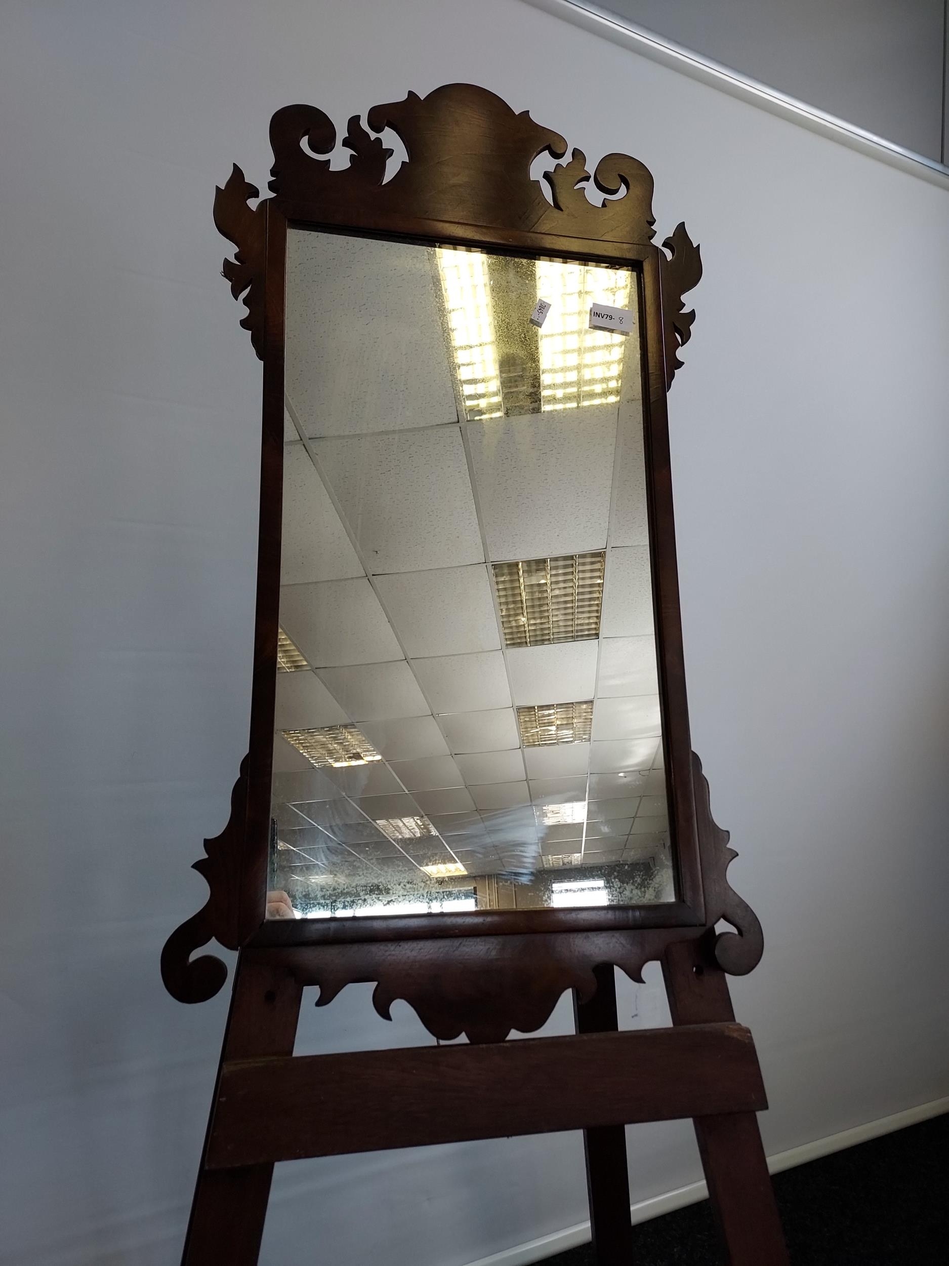 A Georgian mahogany framed mirror. In a Chippendale style, shaped crested top top and bottom [80cm