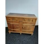 An Art Deco two door, two drawer sideboard, Made from oak. [91x120x48cm]