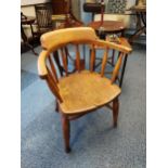 A 19th century elm wood smokers arm chair. [83cm in height]