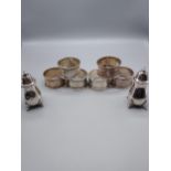 A Set of 6 Sheffield silver napkin rings together with two Birmingham silver pepper pots. All