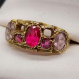An Antique 15ct gold ornate ladies ring set with large single pink stone [possibly ruby], two purple