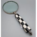 A Large magnifying glass designed with a checker handle. [26.5cm in length]
