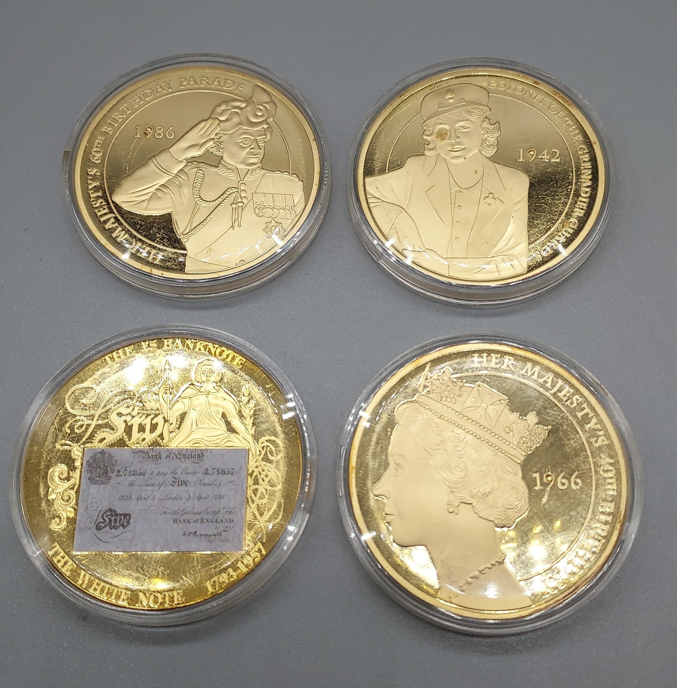 A Lot of four gilt plated coins with protective cases.