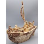 An Antique Japanese Meiji period ivory carved sailing boat, designed with three carved figures,
