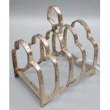 A Sheffield silver four slice toast rack. Produced by Harrods Ltd. [83.43grams]