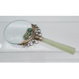 An Antique Chinese jade handle magnifying glass. Designed with a white metal neck support fitted