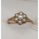 A Ladies 9ct gold and pearl set ring. Seven pearls set like a flower. [Ring size O] [1.59 Grams]