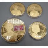 A Lot of four gilt plated Royalty collectors coins with protective cases.