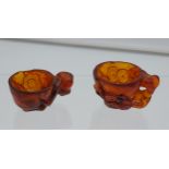 Two Antique Chinese hand carved Amber Libation cups. Both designed with flowers and foliage. [2.