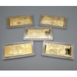 A Lot of five British gilt plated bank note ingots with protective casings.