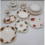 A Collection of various Royal Albert design plates, cake plates, tea pot, sugar and cream etc