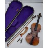 A 19th century antique violin, two bows and coffin carry case. Voigt & Violins Ltd rest.