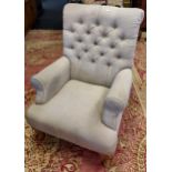 A Contemporary antique style button back arm chair.