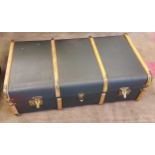 A Vintage travel trunk with wooden and brass bounds.