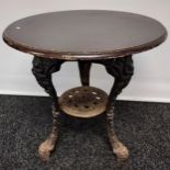 A Vintage cast iron base table with wooden round top. [69cm in height]