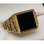 A Gent's 9ct gold signet ring set with an onyx stone. [Ring size U] [4.21grams]