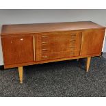 A Retro teak mid century sideboard designed with two doors and four drawers. [77.5x151x44cm]