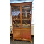 An Antique Two door glass section bookcase with two door cupboard storage to the base. [