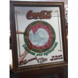 A Vintage Coca Cola advertising mirror. Fitted within an oak frame. [Frame measures 60x50cm]