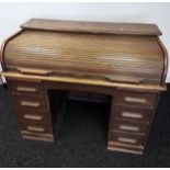 Antique knee hole roll top writing desk. Designed with 9 drawers and interior storage. [