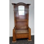 An Art Deco hall way coat stand, fitted with a seat area/ storage area, mirror and various hanging