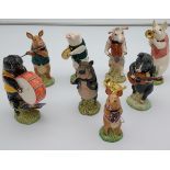 A lot of 8 Beswick pig band [flute one looks to be glued back on and brass player instrument has