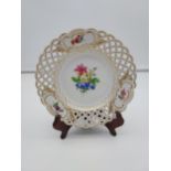 A hand painted Meissen pierced dish, Painted with gilt trims and a bouquet of flowers to the centre.