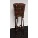 A Scottish made barrel planter with stand. Stand is designed with barley twist supports. [105cm in