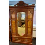 A 19th century ornate mirror front wardrobe. Designed with a single under drawer and various