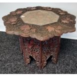 A 19th century Octagonal hand carved Indian table. Designed with an ornate copper insert to the