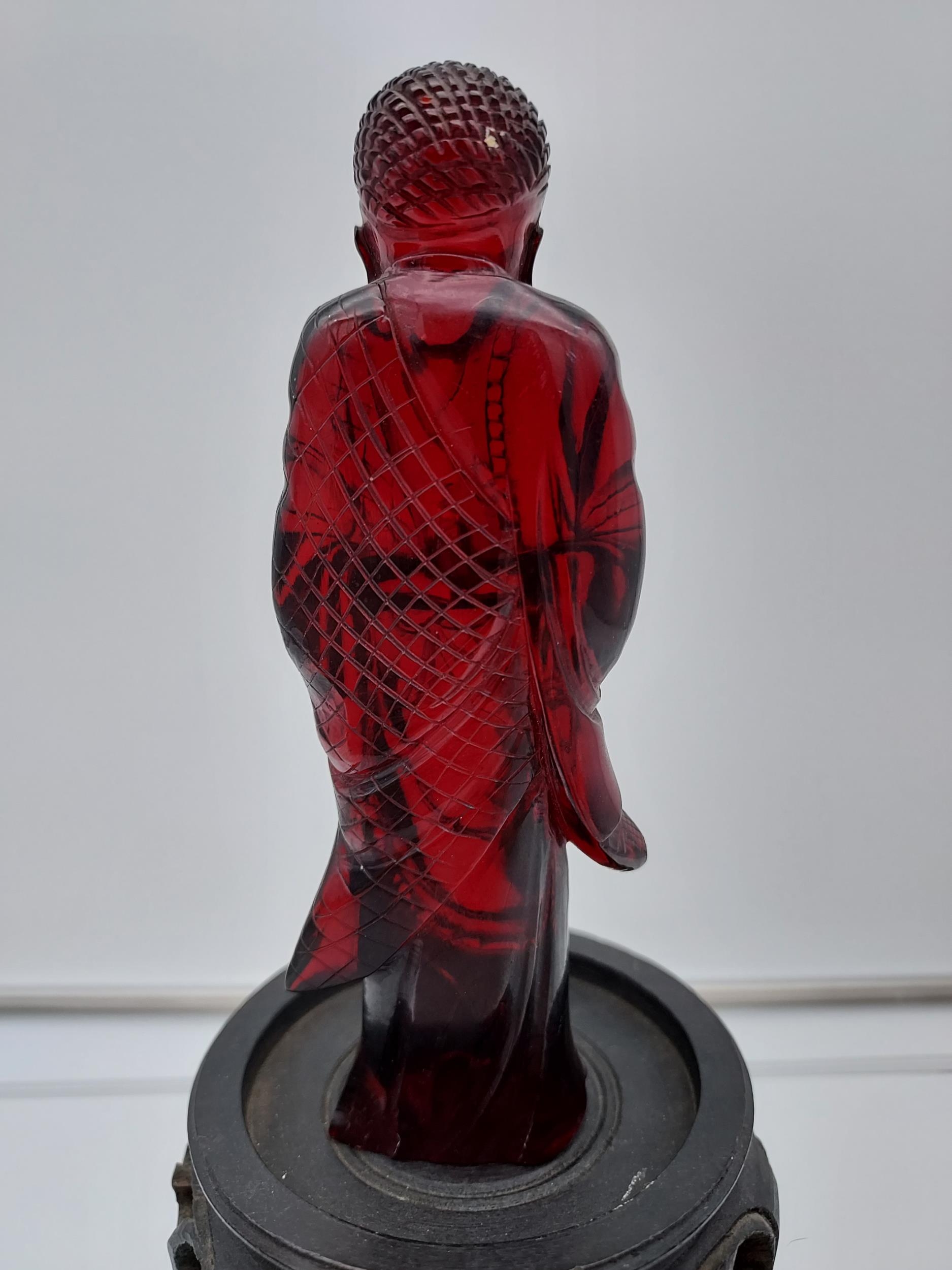 A 19TH Century Chinese hand carved Cherry amber buddha figurine with a hand carved wooden base. [ - Image 6 of 10