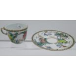 A 19th century Chinese cup and saucer, hand painted with flowers and birds.