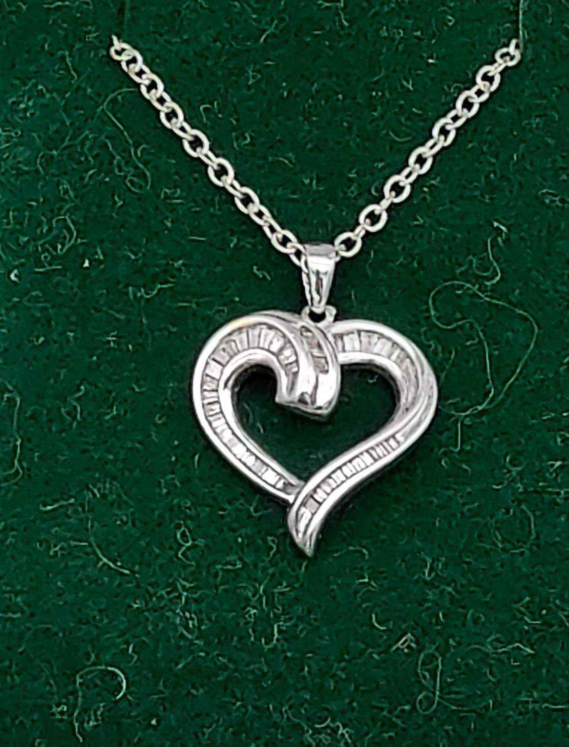 A white gold heart shaped pendant necklace set with baguette diamonds [6.12g]