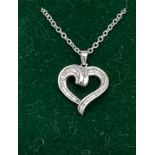 A white gold heart shaped pendant necklace set with baguette diamonds [6.12g]