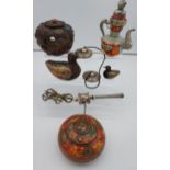 A collection of Tibetan antiques to include silver and copper teapot, prayer wheel, meditation chime