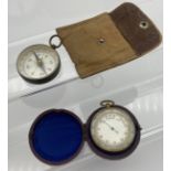 Antique pocket compass together with a gold plated pocket barometer with red protective casing.