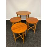 A Mid century teak oval side table with three pull out circular drop end tables.