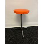 A Three legged mid century kitchen stool. Original orange covering [57cm]