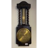An Antique Rattray Dundee brass face wall barometer. Fitted within a dark oak body. [69cm in length]