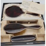 An Antique London silver and tortoise shell dressing table set with a fitted travel box.