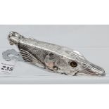 A large silver plated document holder in the form of a fish with glass eyes