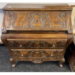 A Reproduction antique style two drawer ornate writing bureau. Comes with key. [93x86x42cm]
