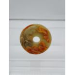 A Chinese Jade/ hardstone hand carved large disc detailed with Pumas [8.5cm in diameter]
