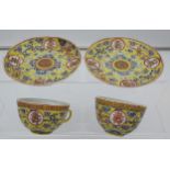 Two Chinese cups and saucers in a yellow ground, Guangxu 1875-1908 signature to the base.