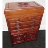 Oriental hardwood chest designed with lift top section, four drawers & two door storage area [