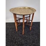 Antique Indian/ Benares decorative brass top wit folding bamboo table legs, Decoratively carved.