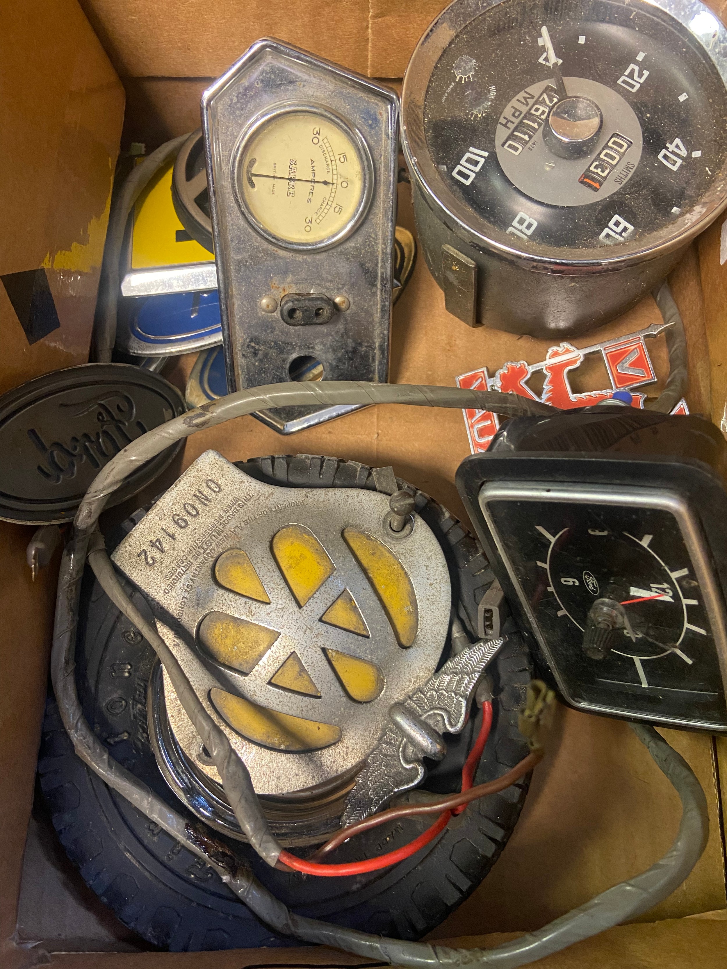 A Box of vintage car badges, clocks and gauges. Includes Smiths MPH Gauge, Sabre Amperes gauge and - Image 2 of 3