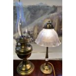 Antique heavy brass table lamp together with a brass body paraffin lamp.